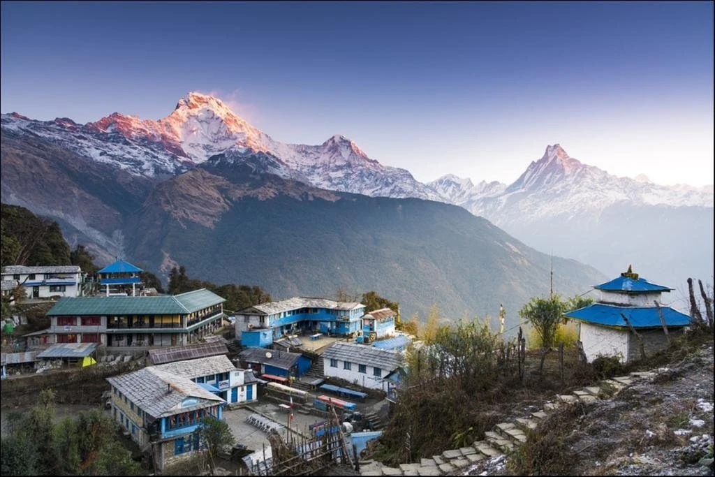 Traditional mountain village in the Annapurna region of Nepal with Himalayan peaks