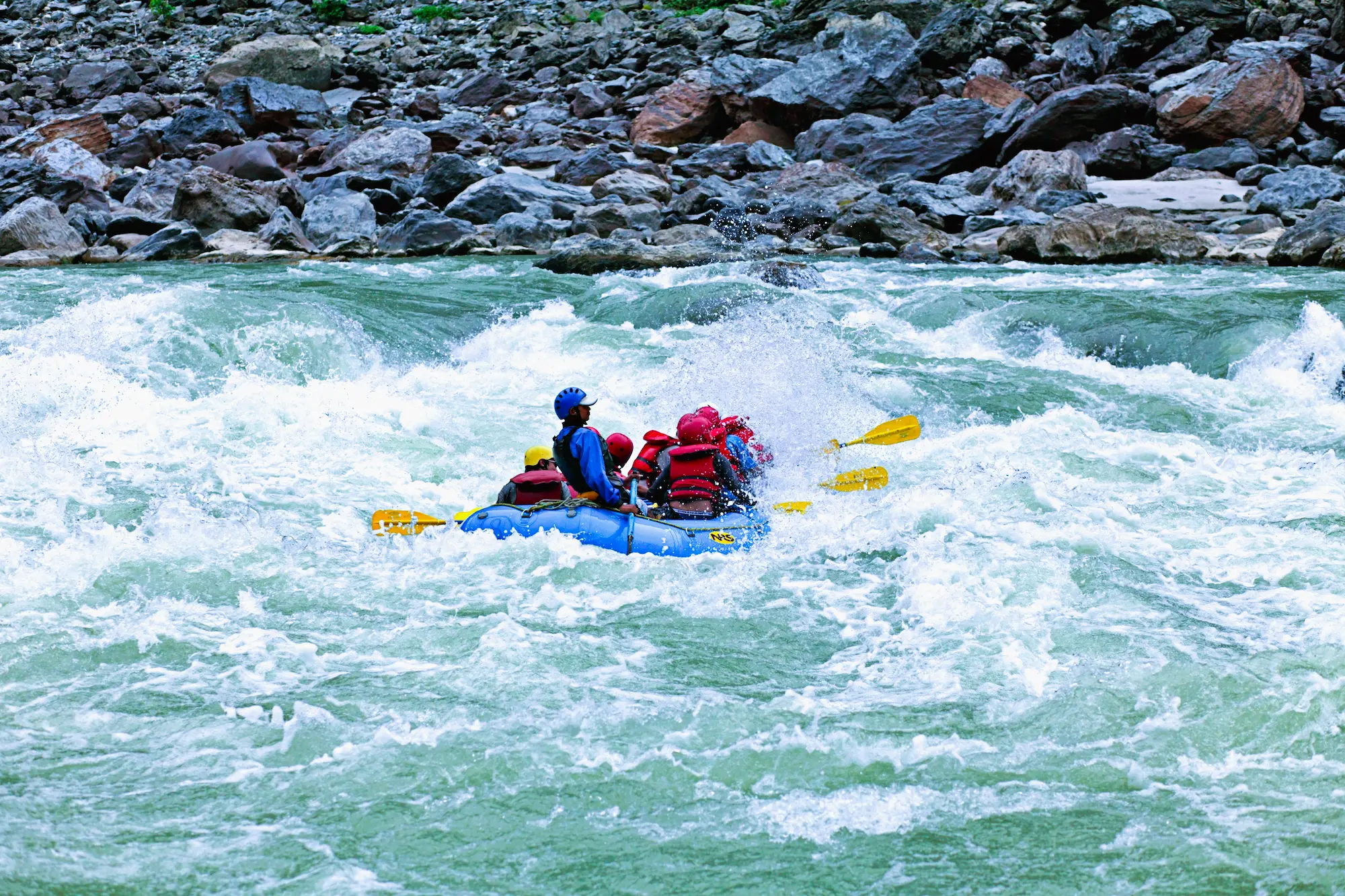 Rafting team navigating powerful white water rapids on the Karnali River in Nepal