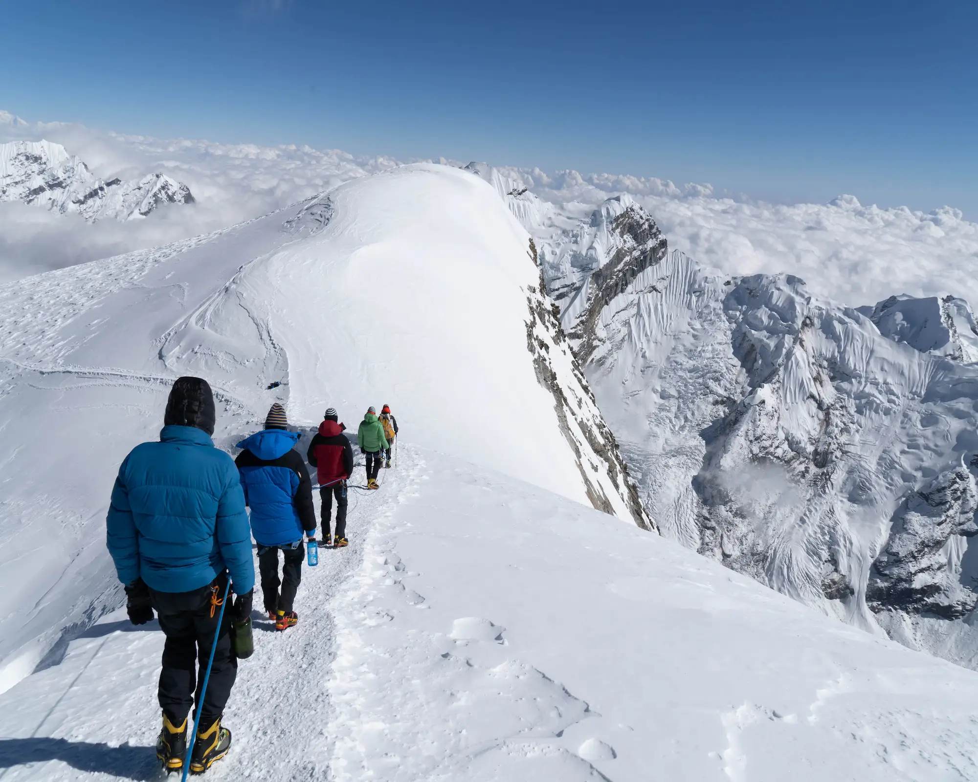 Climbers approaching a 6000m peak in Nepal during a high altitude expedition